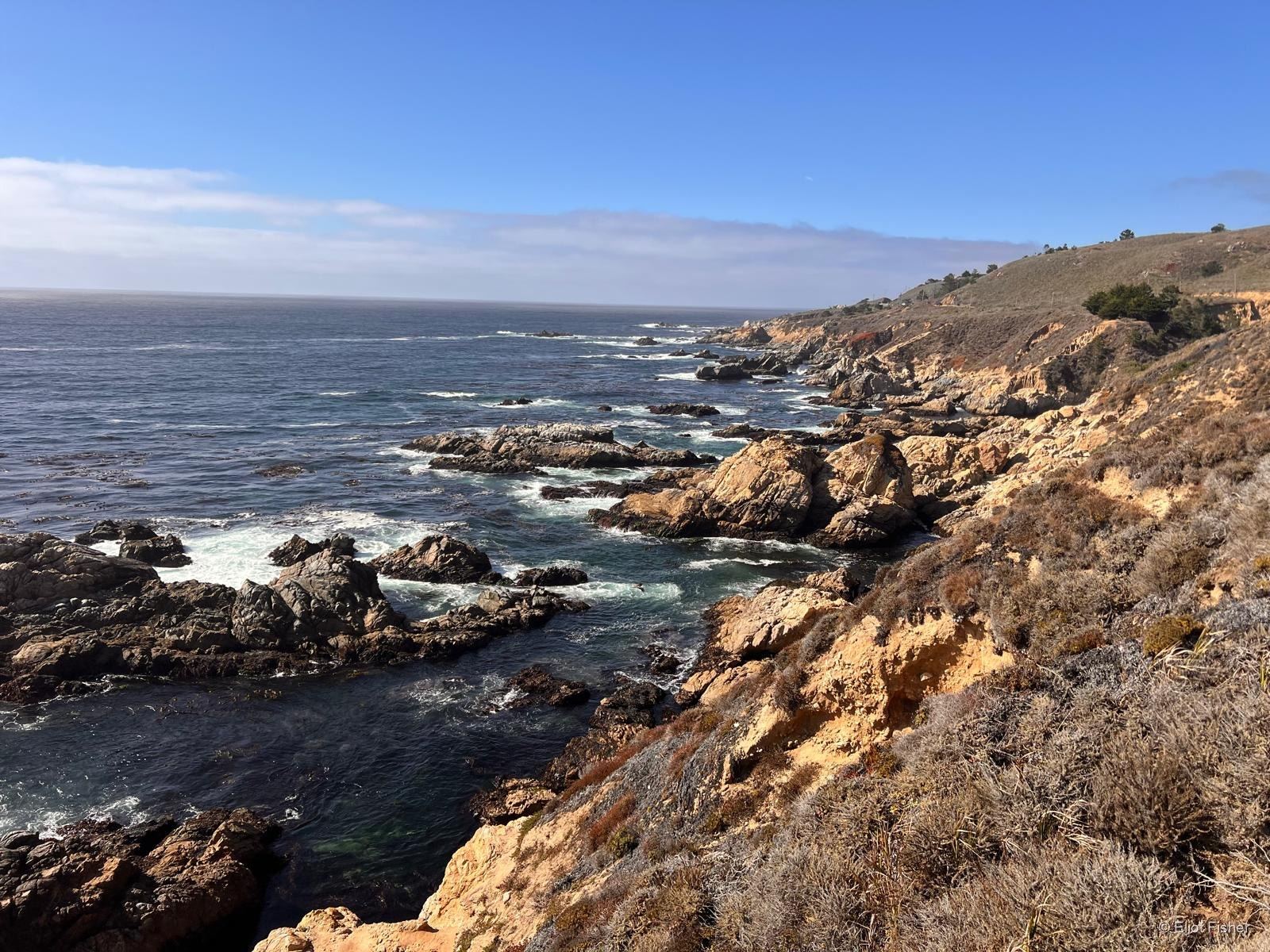Eliot Fisher’s photograph of a rocky coast on a clear day