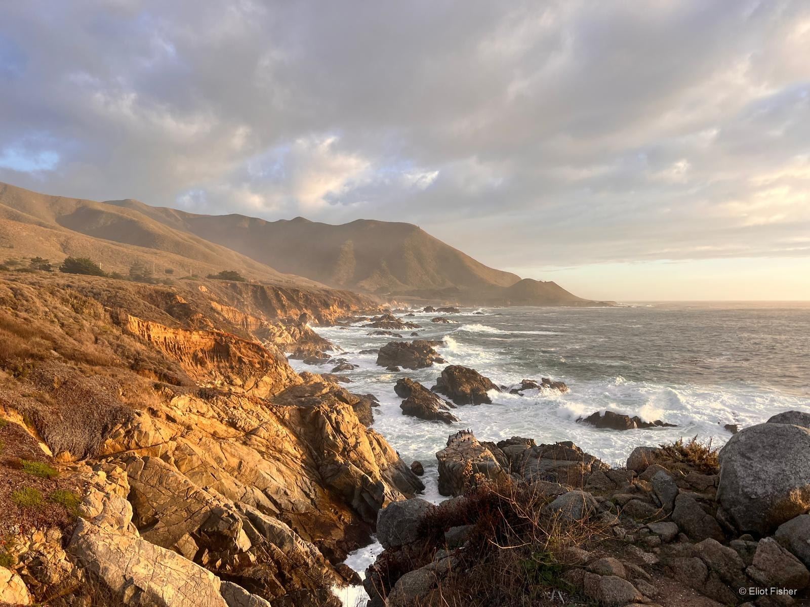 Eliot Fisher’s photograph of coastal cliffs in golden evening light